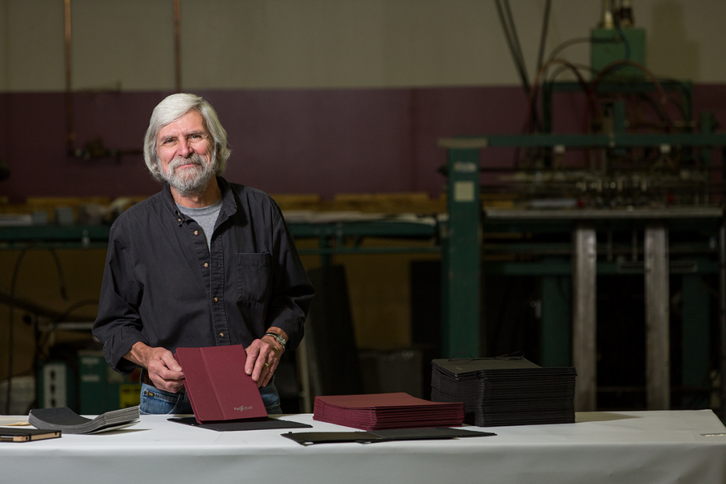 Trendex employee smiling with leather tablet case
