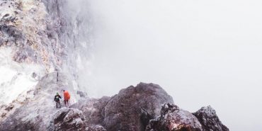 two people starting to climb a mountain