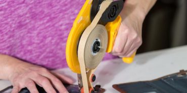Trendex employee applying glue to phone case