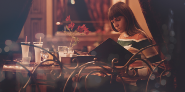 woman looking at restaurant menu