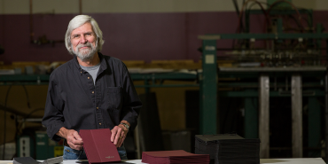 Trendex employee smiling with leather tablet case