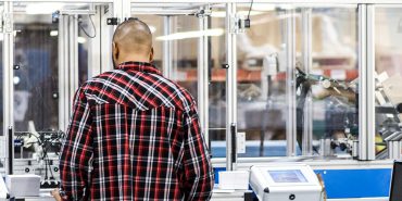 man ticketing fabric memos on machine
